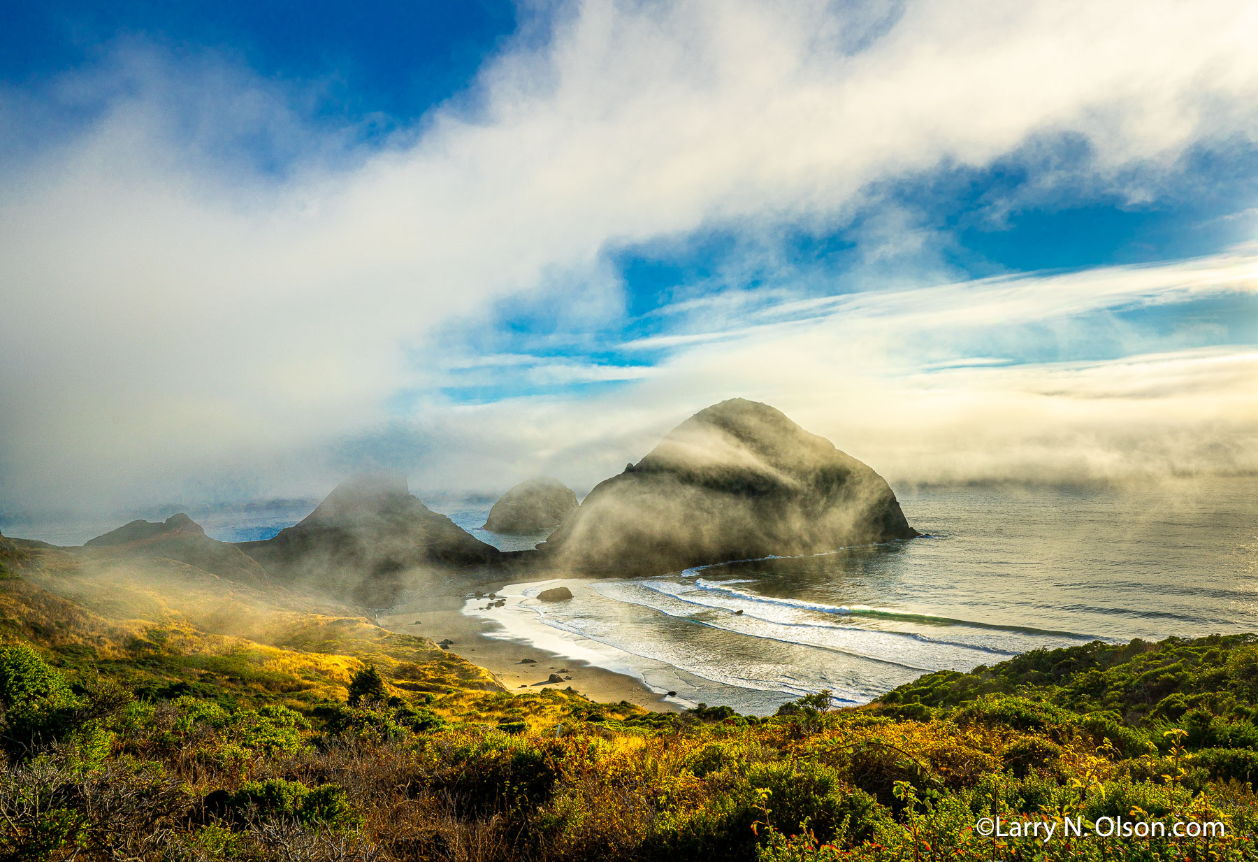 Sisters Rock State Park, Oregon | Driving south from Port Orford in a dense summer sea fog, the late evening breeze magically offered me this glimpse of Sisters Rock. I had to pull over and make photographs until the fog began to settle in again.