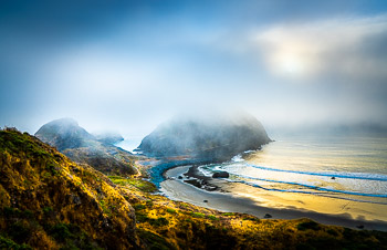 Sisters Rock State Park, Oregon | Driving south from Port Orford in a dense summer sea fog, the late evening breeze magically offered me this glimpse of Sisters Rock. I had to pull over and make photographs until the fog began to settle in again.
