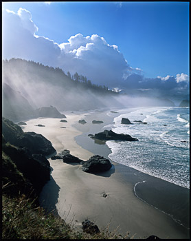 Crescent Beach#1, Ecola State Park, OR | Dramatic light illuminates the clouds and coastline and surf rolls onto the beach at low tide.