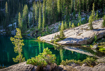 Alpine Lake, Sawtooth Mountains WIlderness, ID | Emerald green Apine Lake reflects the forest in the early morning light.