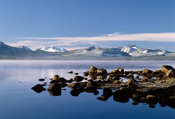 Waldo Lake, Diamond Peak ,OR | A calm Waldo Lake , Diamond Peak, and a rocky peninsula are dusted with the first snows of November.