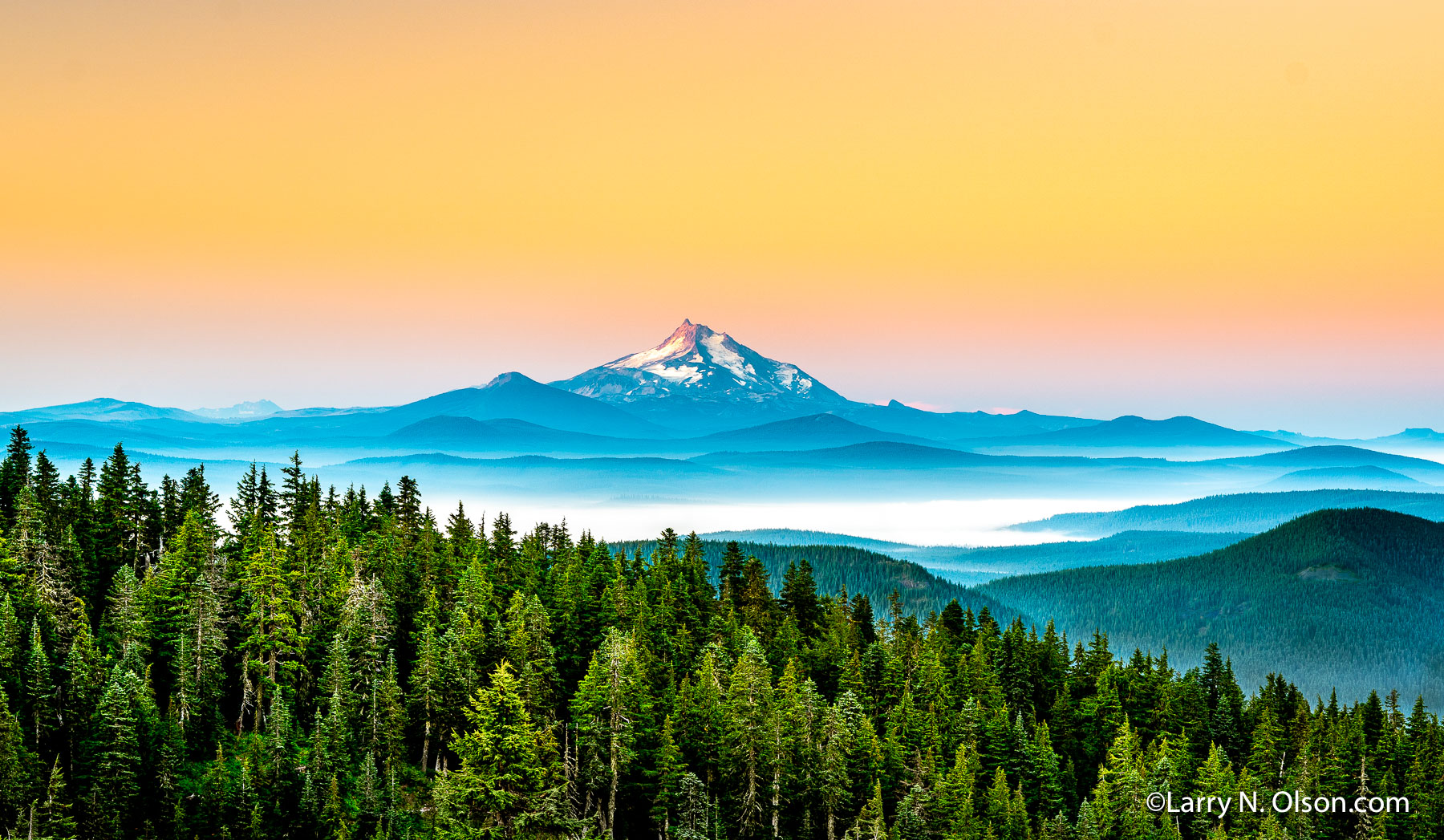 Mount Jefferson, Mount Hood Wilderness, OR | Pre-dawn light on Mount Jefferson as seen from Mount Hood. This photograph was made on a summer backpacking trip to Mt. Hood’s Paradise Park.  The Ollallie Lakes basin is shrouded by fog in the foreground. As of early October 2020, the Lionshead Fire was still burning in this area.