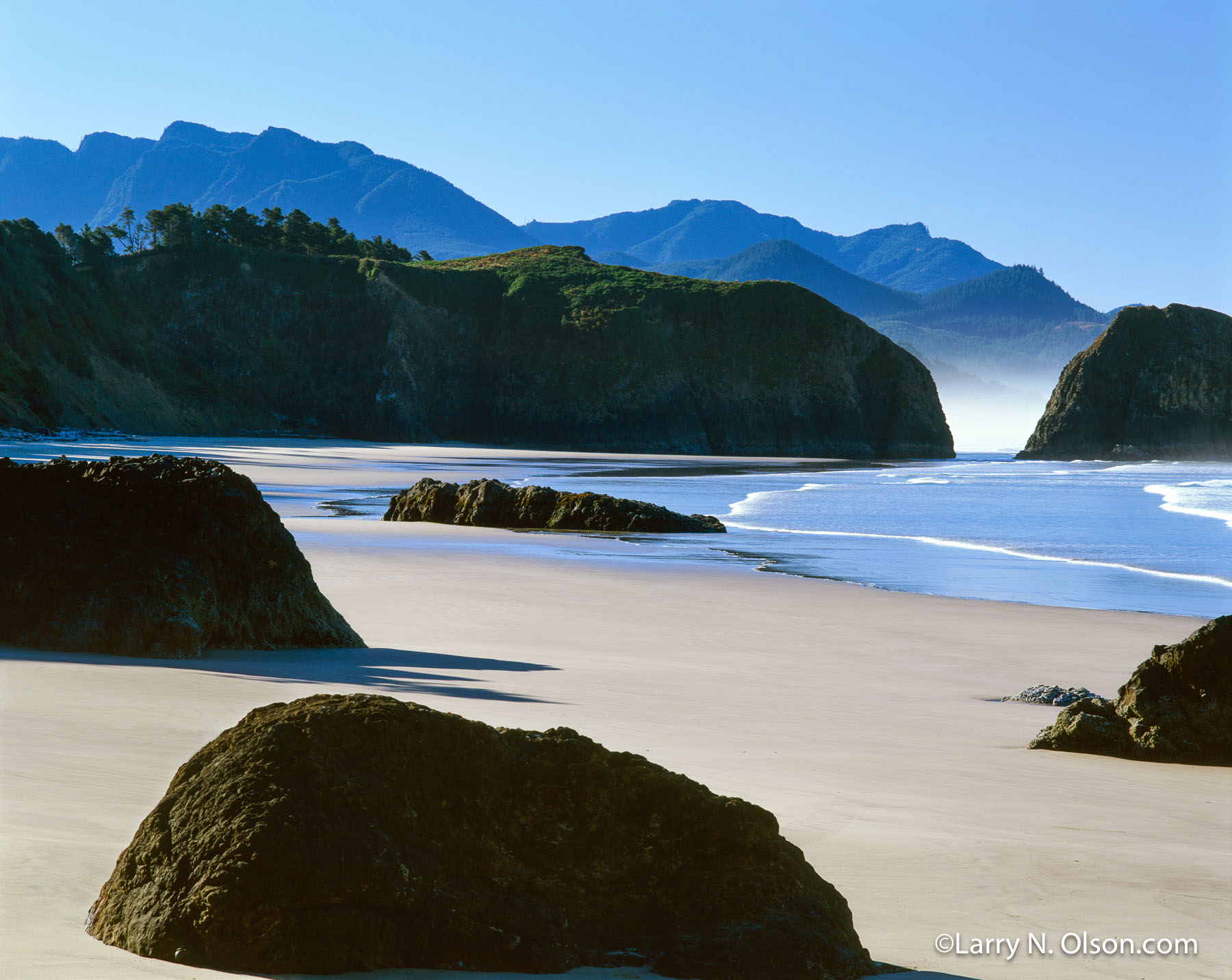 Low Tide#1, Ecola State Park, Oregon | Big black rocks are silhouetted against an empty Oregon beach at low tide.