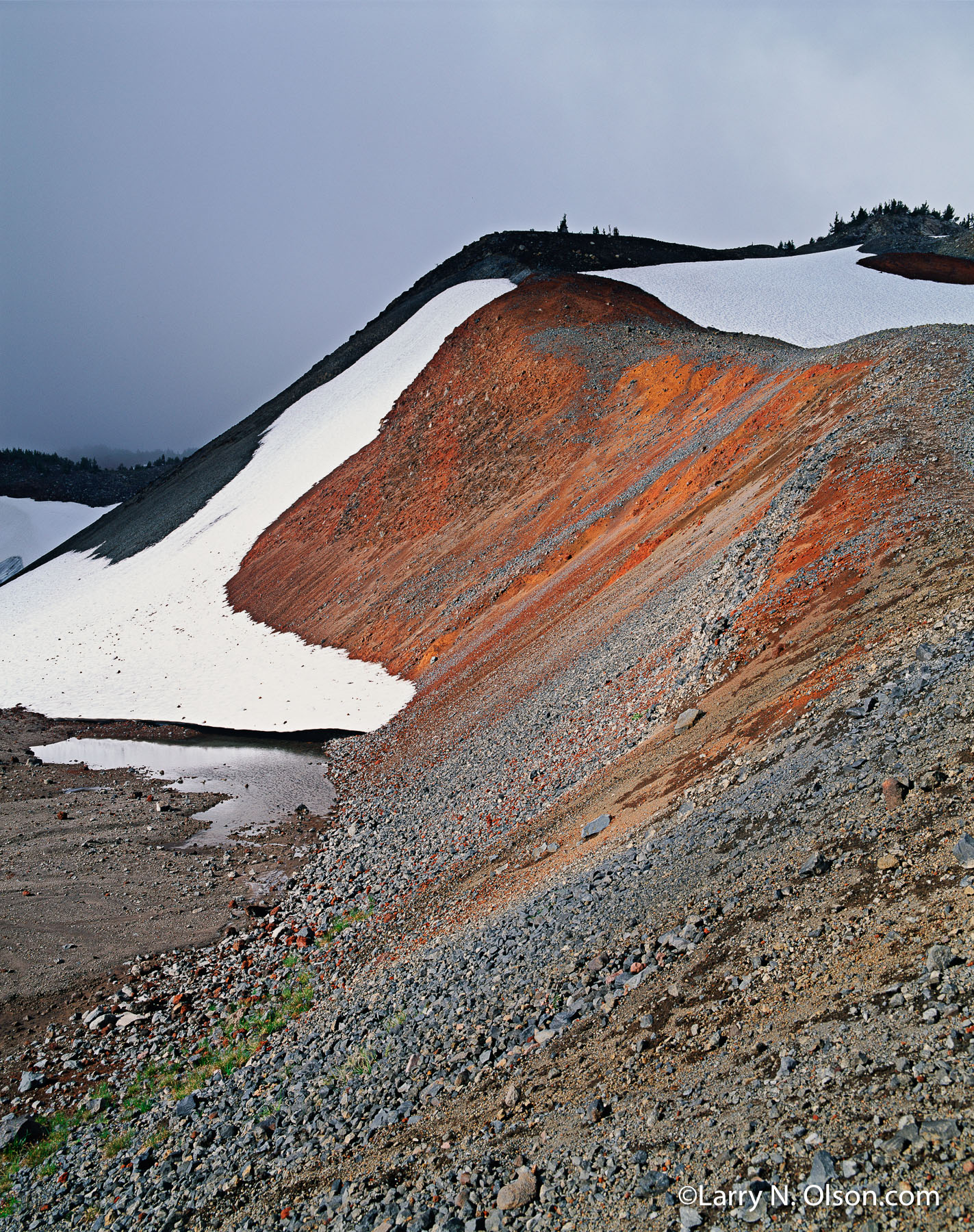 Cinder Slope, Three Sisters Wilderness, OR | Snow covered, rusty red volcanic cinders can be seen in the lateral morain of an ancient glacier.