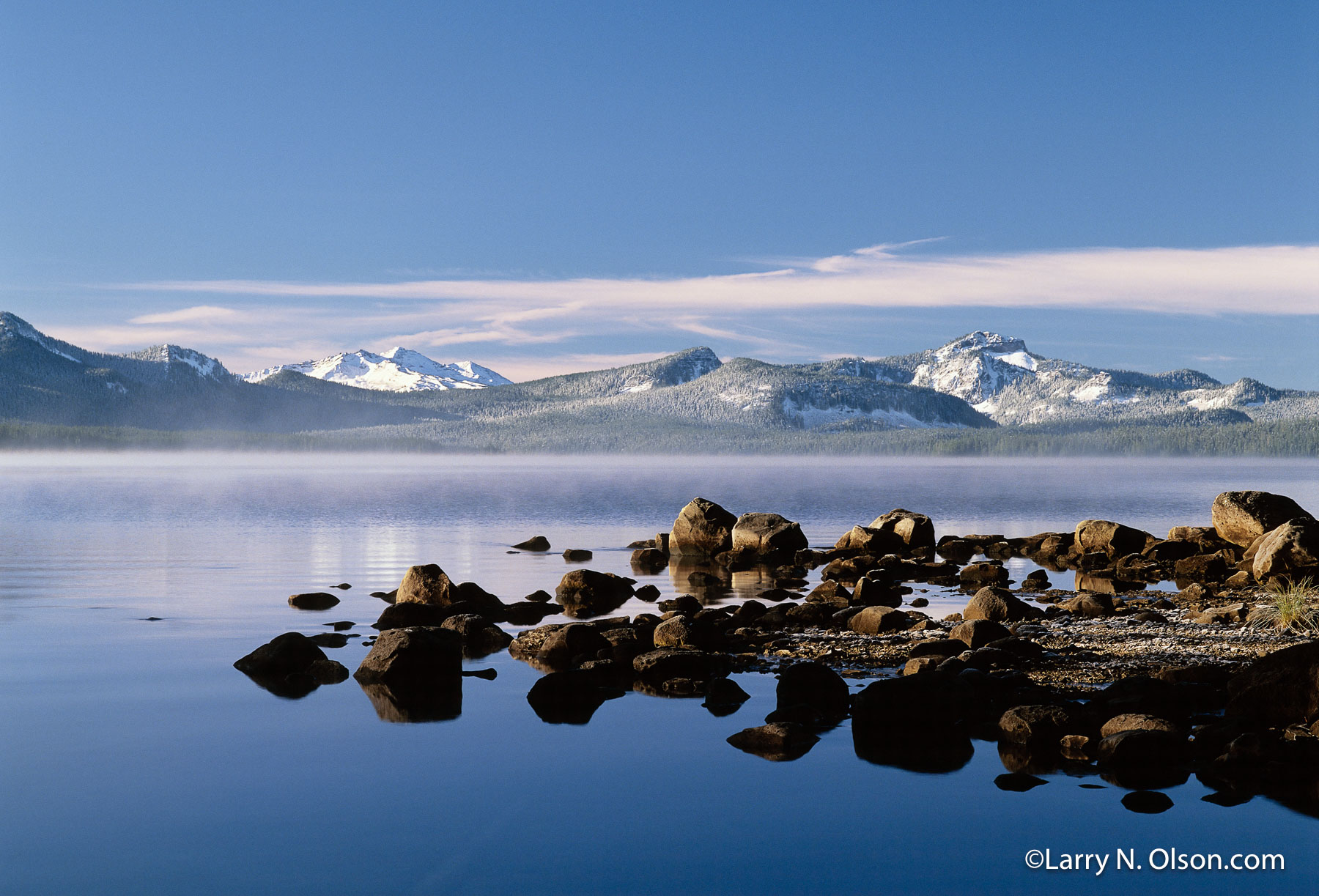 Waldo Lake, Diamond Peak ,OR | A calm Waldo Lake , Diamond Peak, and a rocky peninsula are dusted with the first snows of November.