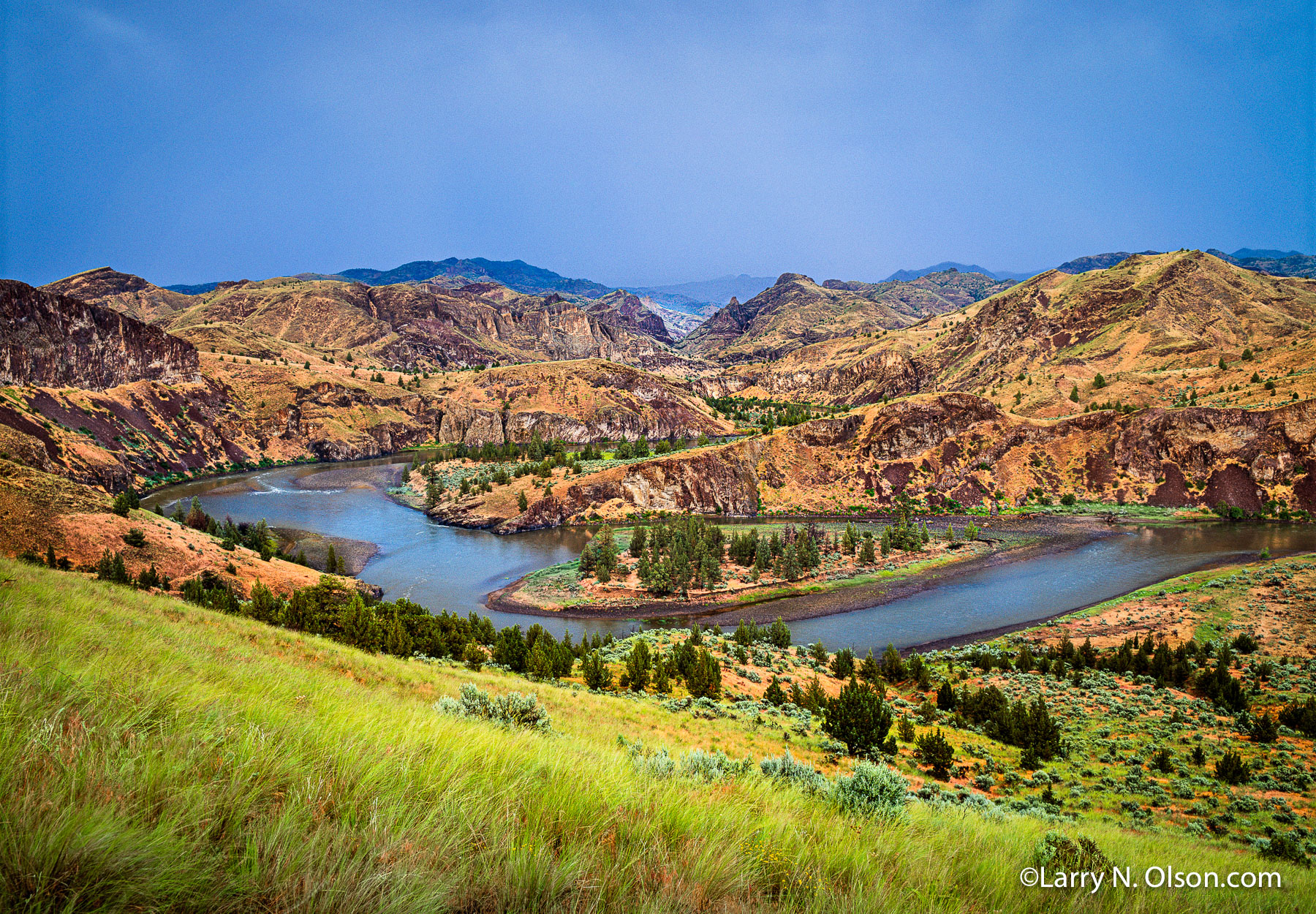 Big Bend, John Day River, OR | The sun emerges after a storm lighting the Bunchgrass in the  canyon labrynth.