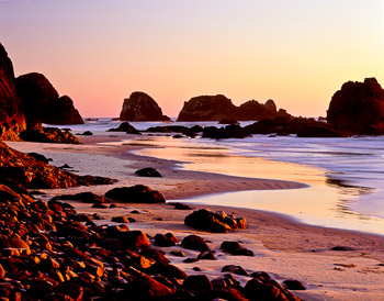 Ecola State Park #2, Oregon | The salmon pink twilight is reflected in the wet sand on a pocket beach protected by offshore islands and haystack rocks.