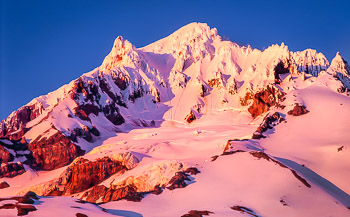 Alpenglow, Mt. Hood, OR | The alpenglow on the mountain and summit pinnacles  above the Sandy Glacier is caused by Red Algae on the snow surface.