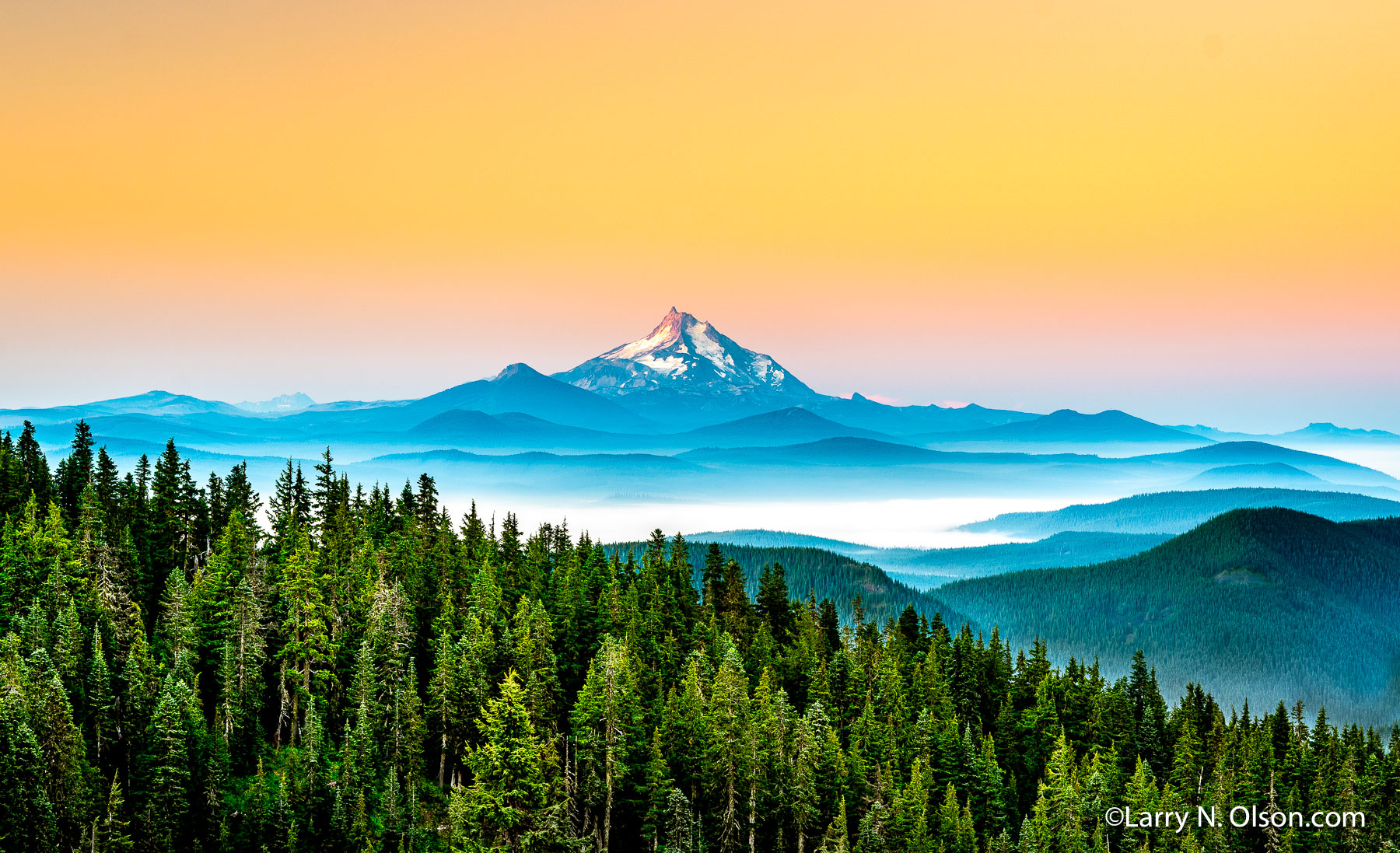 Mount Jefferson, Mount Hood Wilderness, OR | Pre-dawn light on Mount Jefferson as seen from Mount Hood. This photograph was made on a summer backpacking trip to Mt. Hood’s Paradise Park.  The Ollallie Lakes basin is shrouded by fog in the foreground. As of early October 2020, the Lionshead Fire was still burning in this area.