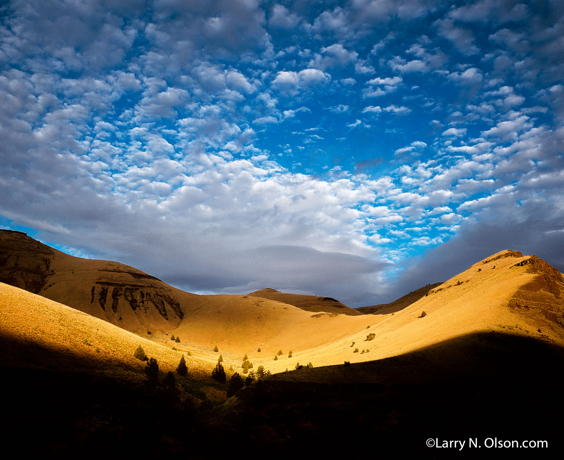 Lower Gorge, John Day River, OR | Setting sun spectacularly illuminates golden hillside and dramatic clouds in the John Day River Canyon.