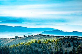 Ancient Bristlecone Pine Forest, CA | Dawn clouds partially obscure ridgelines in the White Mountains of California. The far distance is Death Valley National Park.