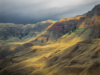 Imnaha River Canyon, OR | The illusive storm-light creates a vivid landscape in the Oregon High Desert. The basalt canyon slopes have a velvet look with the new growth of Bunchgrass. Hells canyon and the Snake River is just over the ridgeline.